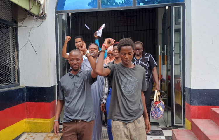 Journalist Peter Maseke Mwita (left) walks out of Central Police Station in Mombasa in handcuffs on January 2, 2026.