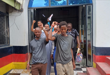 Journalist Peter Maseke Mwita (left) walks out of Central Police Station in Mombasa in handcuffs on January 2, 2026.