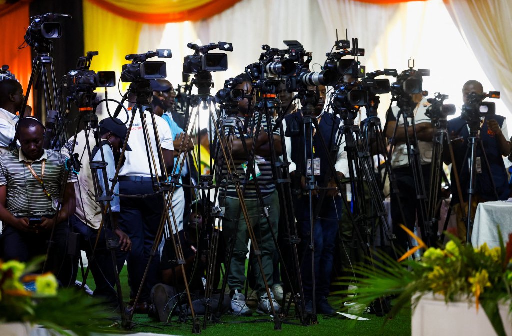 Ugandan journalists cover the announcement of presidential results in January.