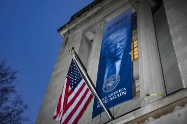 A new banner depicting U.S. President Donald Trump is put up on the Department of Justice building in Washington, D.C., U.S., February 20, 2026. REUTERS/Ken Cedeno