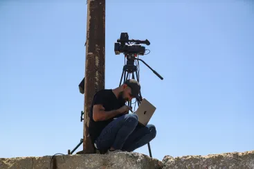 A Palestinian man attempts to access the internet using an eSIM in Gaza City after the internet and fixed-line communications services were cut off amid the Israeli offensive, in June.