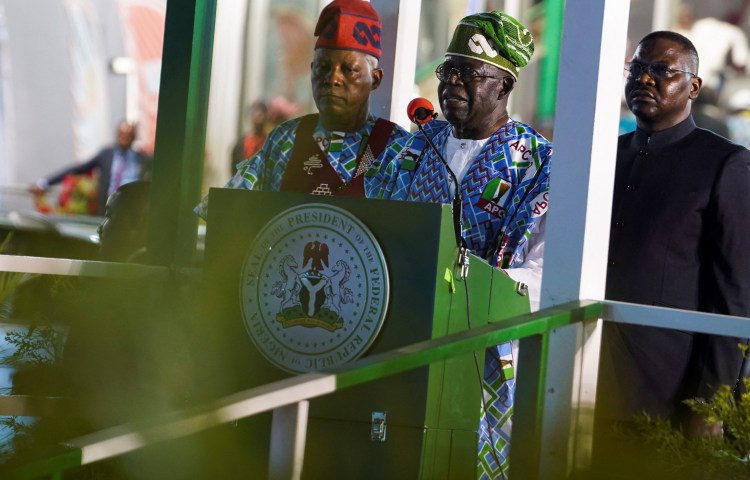 Nigeria's President Bola Ahmed Tinubu delivers a speech as Vice President Kashim Shettima stands beside him in Abuja on March 27.