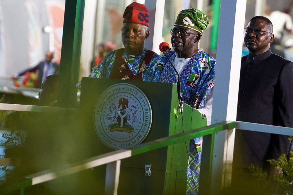 Nigeria's President Bola Ahmed Tinubu delivers a speech as Vice President Kashim Shettima stands beside him in Abuja on March 27.