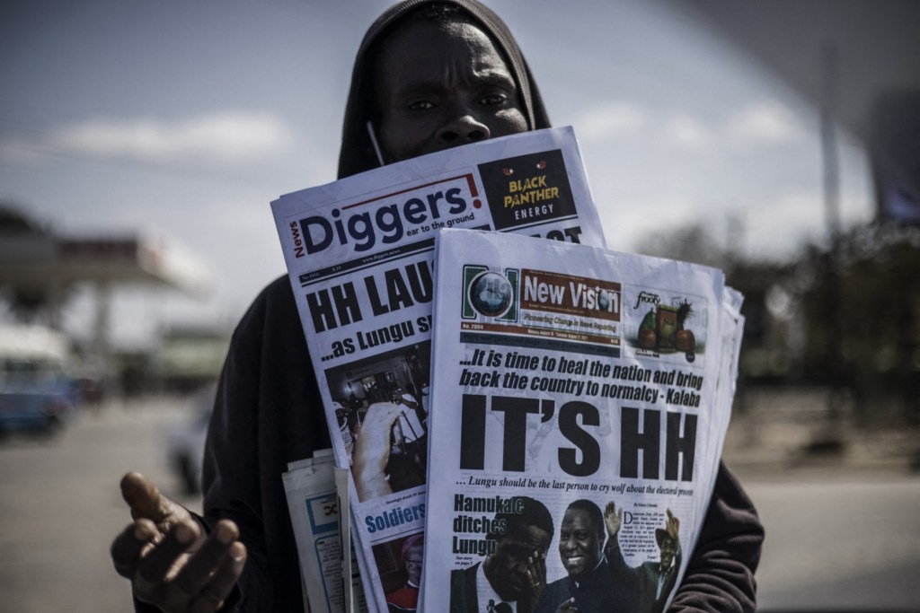 A newspaper vendor carrying Zambian dailies on August 16, 2021, reporting that business tycoon and veteran opposition leader Hakainde Hichilema had won the presidential election with an overwhelming majority.