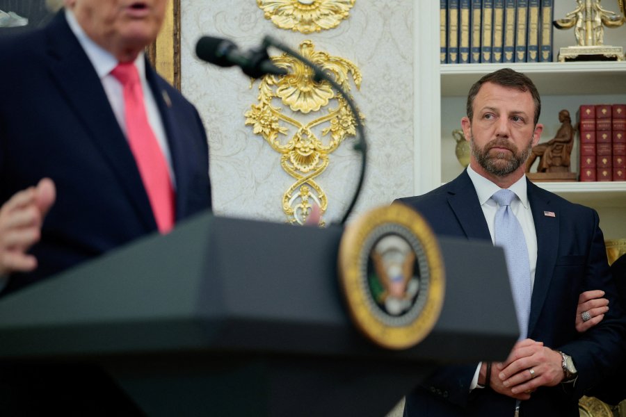 Markwayne Mullin stands listening to U.S. President Donald Trump as he attends his swearing-in as Department of Homeland Security (DHS) Secretary, at the White House in Washington, D.C., U.S., March 24, 2026. REUTERS/Evan Vucci