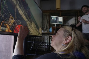 Activists in Athens watch the interception of one of the vessels from the Gaza-bound Global Sumud Flotilla on a video transmission.