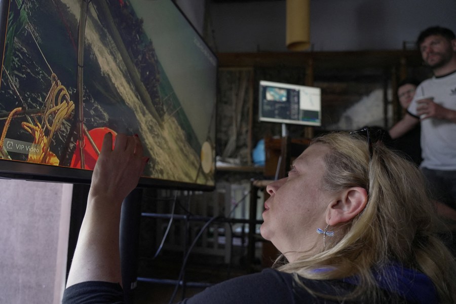 Activists in Athens watch the interception of one of the vessels from the Gaza-bound Global Sumud Flotilla on a video transmission.