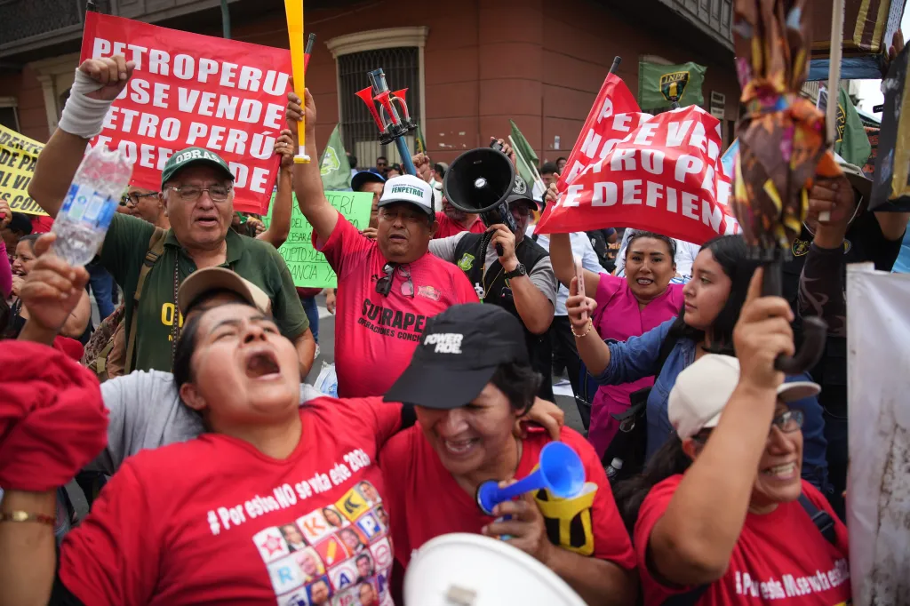Demonstrators celebrate after Congress voted to remove interim President Jose Jeri as he faces corruption allegations outside the site where lawmakers met in Lima, Peru, Tuesday, Feb. 17, 2026. (AP Photo/Guadalupe Pardo)