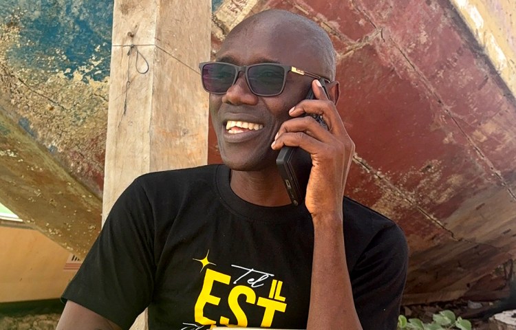 As he looks at the ocean, which he had not seen in nearly a decade, journalist and author René Capain Bassène tells his family that he has been freed from prison on May 27, 2026, less than an hour after his release. (Photo: CPJ/Moussa Ngom)
