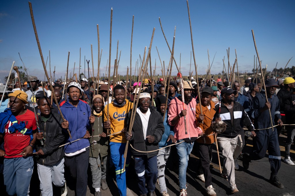 Demonstrators carry sticks during a protest calling for the deportation of undocumented immigrants, as violence against migrants from other African countries increases, in Benoni, east of Johannesburg, South Africa, June 5.