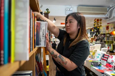 Leticia Wong Man-huen arranges books at her bookstore in Hong Kong on June 20, 2025. (Photo: AP/Chan Long Hei)