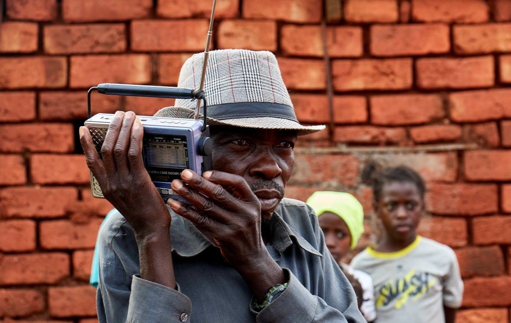 A displaced Congolese man listens to the radio outside his shelter in Fizi territory of South Kivu province in January.