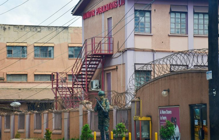 A member of Uganda People's Defence Forces stands at the headquarters of Nation Media Group - Uganda, (NMG-U), a building that houses Daily Monitor, KFM and Dembe FM radios, as government closes the media house, in Kampala, Uganda, June 28, 2026.