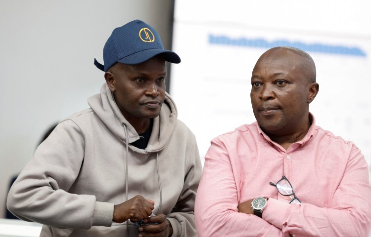 Alex Kiprotich, an associate editor for Standard Group, who was seized by armed men and released hours later, sits with Group CEO Chaacha Mwita, during a news conference at the Standard Group offices in Nairobi, Kenya, on September 2.