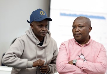Alex Kiprotich, an associate editor for Standard Group, who was seized by armed men and released hours later, sits with Group CEO Chaacha Mwita, during a news conference at the Standard Group offices in Nairobi, Kenya, on September 2.