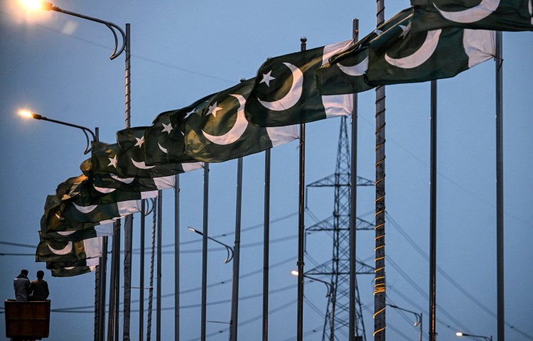 A row of Pakistani national flags line a street in Islamabad on April 18, 2026. Authorities have opened a cybercrime case against Islamabad-based journalist Muhammad Bilal Ghauri over his social media commentary. (Photo: AFP/Farooq Naeem)