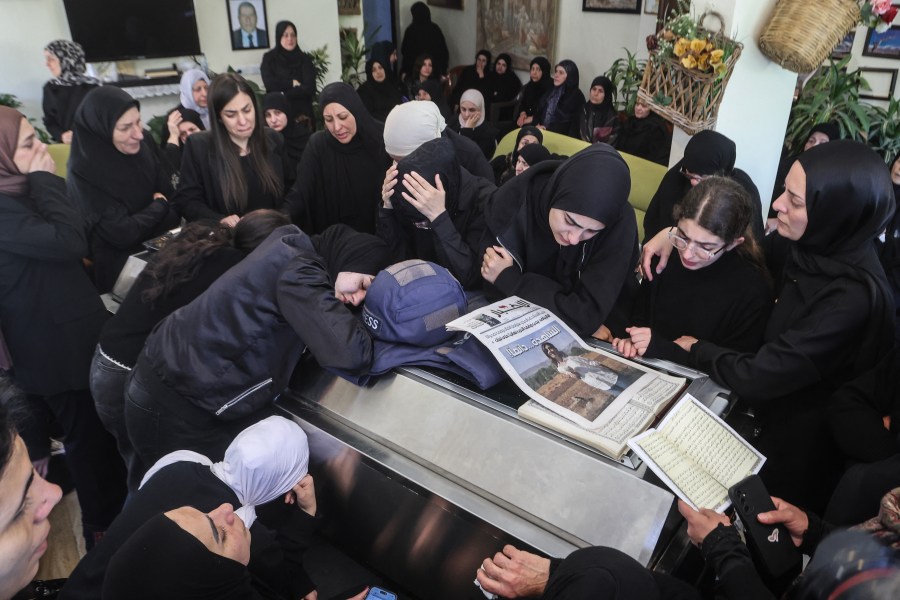 Relatives and friends of Amal Khalil, a veteran correspondent for the daily newspaper Al-Akhbar who was killed in a reported Israeli airstrike in southern Lebanon, mourn at her home in the village of Bisariyeh on April 23, 2026.