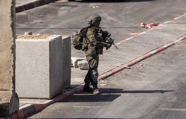 An Israeli soldier stands guard at the northern checkpoint in Hebron, in the occupied West Bank, on October 24, 2026.