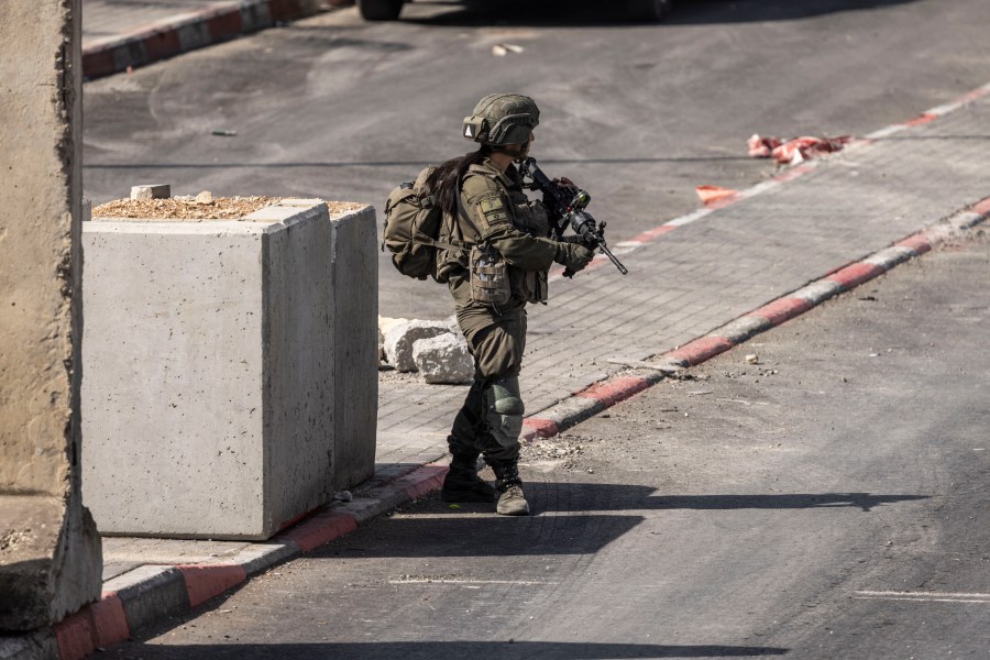 An Israeli soldier stands guard at the northern checkpoint in Hebron, in the occupied West Bank, on October 24, 2026.